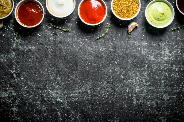 stock image Set of different flavorful sauces. On dark rustic background