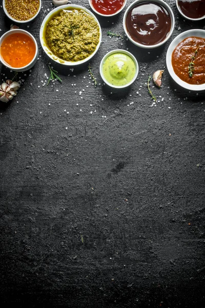 stock image Fragrant delicious sauces. On black rustic background