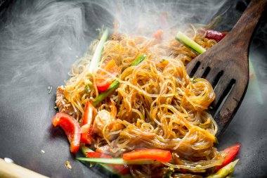 Sebze ve somon ile Sıcak Asya selofan erişte. Rustik arka planda