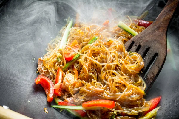 Sebze ve somon ile Sıcak Asya selofan erişte. Rustik arka planda