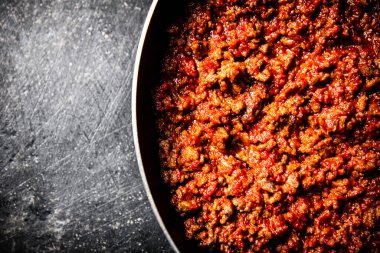 Kızartma tavasında leziz bolonez sosu. Siyah bir arka planda. Yüksek kalite fotoğraf