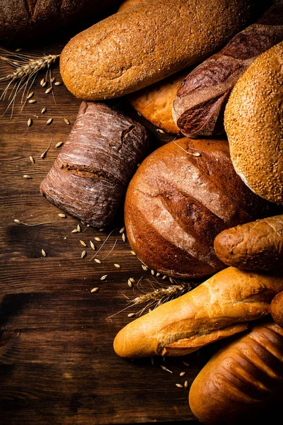 不同种类的美味面包 在木制的背景上 高质量的照片 — 图库照片