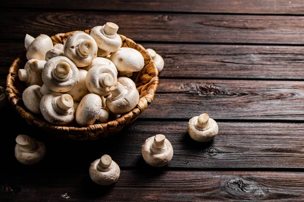 stock image Fresh mushrooms in a basket. On a wooden background. High quality photo