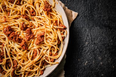 Masada spagetti bolonez hazır. Siyah bir arka planda. Yüksek kalite fotoğraf