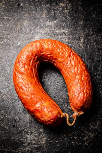 stock image Delicious salami sausage on the table. On a black background. High quality photo