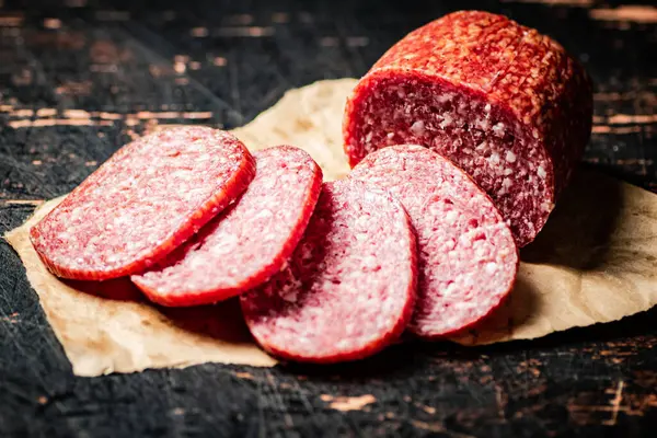 Sliced Salami Sausage Paper Table Dark Background High Quality Photo — Stock Photo, Image