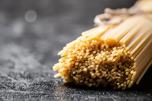 stock image A bunch of spaghetti dry on the table. On a black background. High quality photo