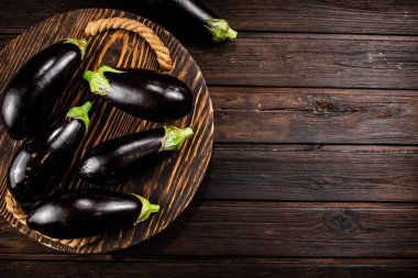Ripe eggplant on a wooden tray. On a wooden background. High quality photo