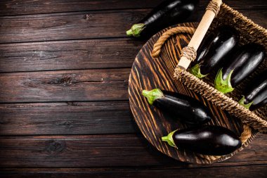 Box on a table with ripe eggplant. On a wooden background. High quality photo