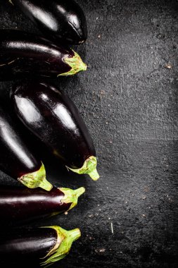 Fresh homemade eggplant on the table. On a black background. High quality photo