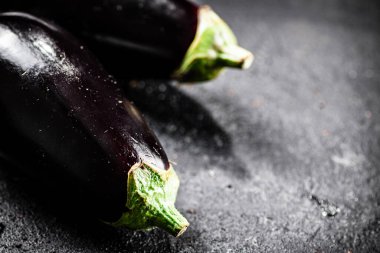 Fresh homemade eggplant on the table. On a black background. High quality photo