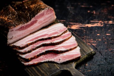 Pork lard cut on a cutting board. Against a dark background. High quality photo
