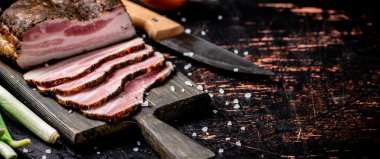 Delicious homemade lard on a cutting board. Against a dark background. High quality photo