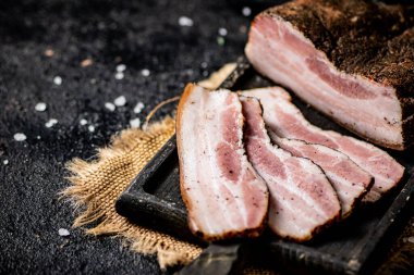 Chopped pork lard on a cutting board. On a black background. High quality photo