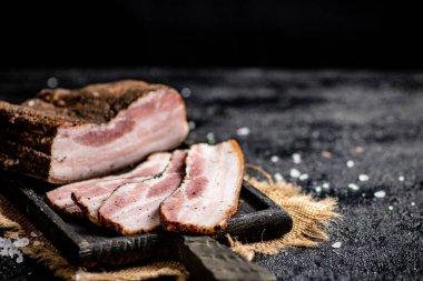 Chopped pork lard on a cutting board. On a black background. High quality photo