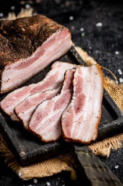 Chopped pork lard on a cutting board. On a black background. High quality photo