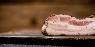 A piece of delicious pork fat lard. On a wooden background. High quality photo