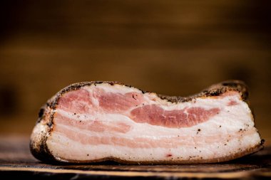 A piece of delicious pork fat lard. On a wooden background. High quality photo