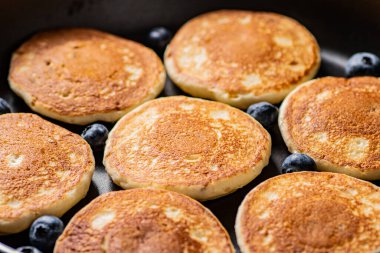 Pancakes with fresh blueberries. Macro background. High quality photo