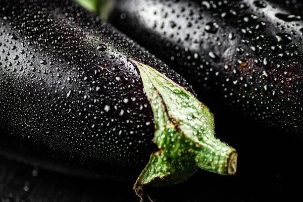 Fresh eggplant with drops of water. Macro background. High quality photo