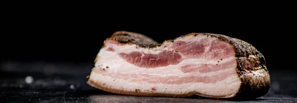 stock image A piece of homemade pork lard on the table. On a black background. High quality photo