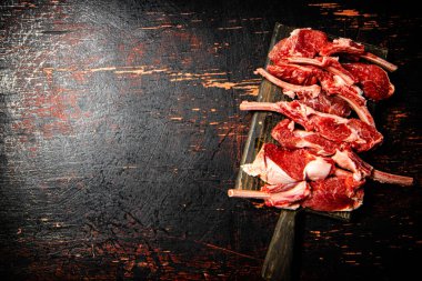 Sliced raw rack lamb. Against a dark background. High quality photo