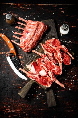 Sliced raw rack lamb. Against a dark background. High quality photo