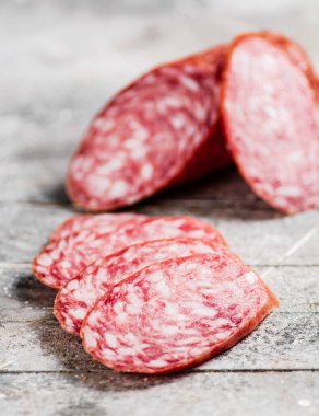 Delicious salami sausage on the table. On a gray background. High quality photo