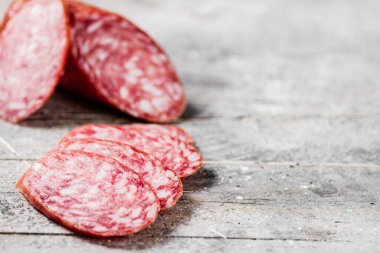 Delicious salami sausage on the table. On a gray background. High quality photo