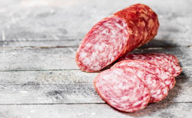 Delicious salami sausage on the table. On a gray background. High quality photo