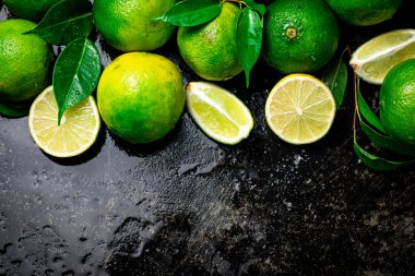 Parçalar ve yapraklı limon. Siyah, nemli bir arka planda. Yüksek kalite fotoğraf