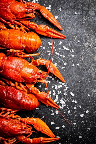 stock image Boiled crayfish with parsley. On a black background. High quality photo