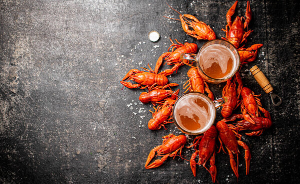 Boiled crayfish with a glass of beer. On a black background. High quality photo