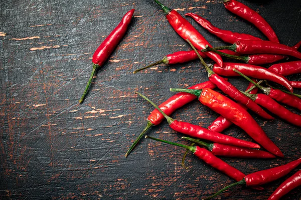 stock image A bunch of hot chili pepper pods. Against a dark background. High quality photo