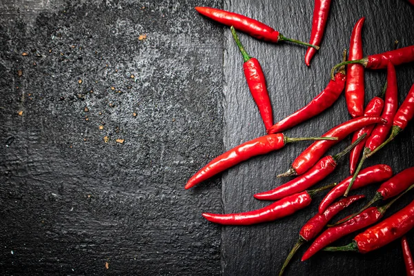 Chili Pepper Pods Stone Board Black Background High Quality Photo — Fotografia de Stock