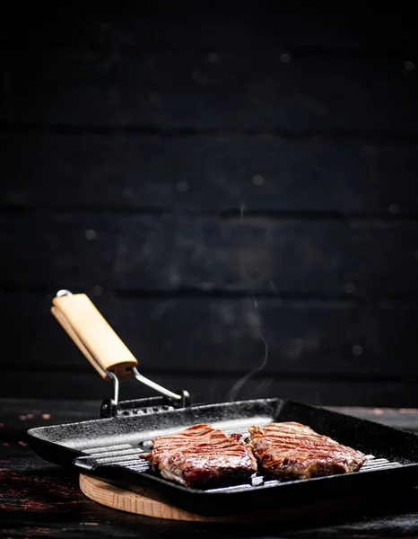 Cooking Grilled Steak Frying Pan Hot Steam Black Background High — стоковое фото