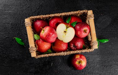 Half and whole fresh apples. On a black background. High quality photo