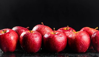 Fresh red apples on the table. On a black background. High quality photo