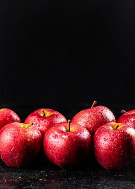 Fresh red apples on the table. On a black background. High quality photo