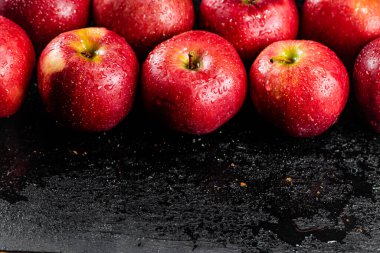 Fresh red apples on the table. On a black background. High quality photo