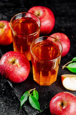 Apple juice on a stone board. On a black background. High quality photo