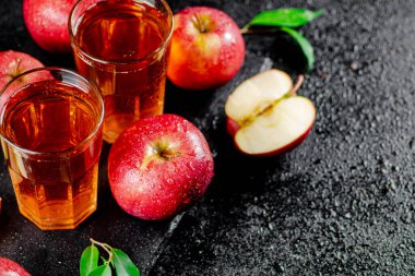 Apple juice on a stone board. On a black background. High quality photo