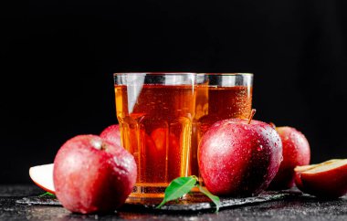 Apple juice on a stone board. On a black background. High quality photo