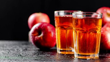 Fresh homemade apple juice. On a black background. High quality photo