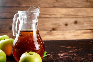 Juice from fresh green apples. On a wooden background. High quality photo