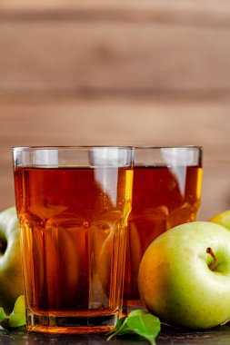 Juice from fresh green apples. On a wooden background. High quality photo