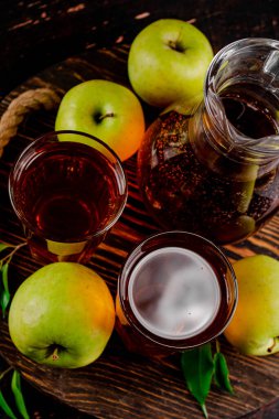 Juice from fresh green apples. On a wooden background. High quality photo