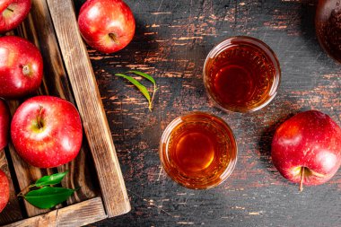 A glass of apple juice on the table. On a rustic dark background. High quality photo