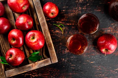A glass of apple juice on the table. On a rustic dark background. High quality photo