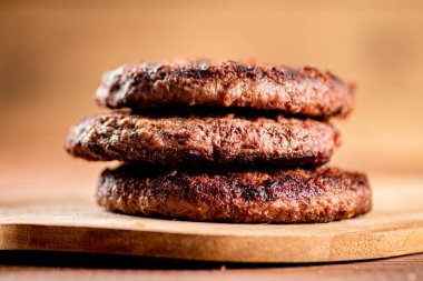 Burger grill on a cutting board. On a wooden background. High quality photo